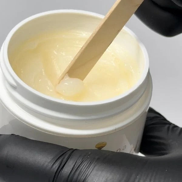 A close-up of a Elleebana protective balm jar it is a great natural great alternative to Vaseline.
Dermatologically tested, Elleeshield protective balm is one of those must-have products in our range. Being a natural product made from sweet almond oil and beeswax, Elleeshield is a protective barrier cream to prevent tint from marking the skin.
This is a great alternative to chemical-based products that could cause damage to your client’s natural lashes and brows.