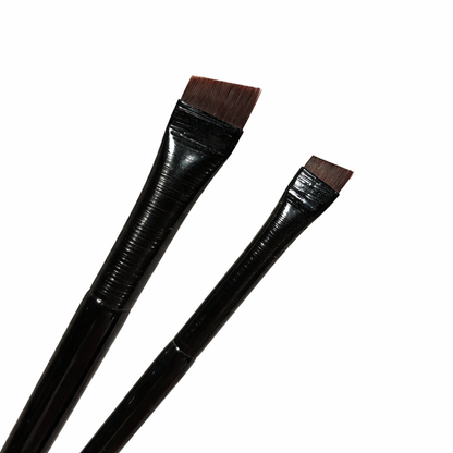 Close up of small and large angled brow brushes for precise eyebrow application