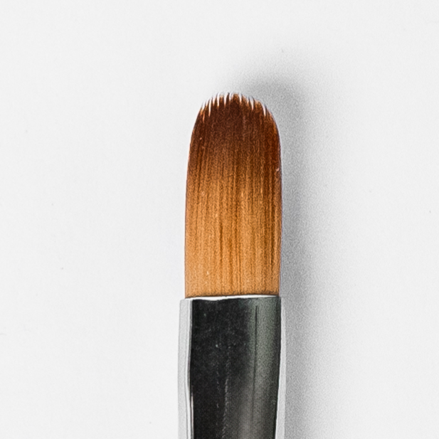 Makeup brush with brown bristles on a white background