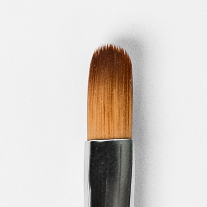 Makeup brush with brown bristles on a white background