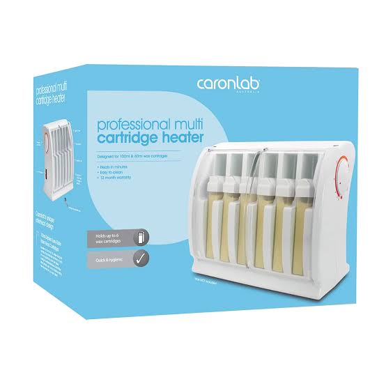 Caronlab Professional Multi Cartridge Heater in its packaging, featuring a white device with six slots containing yellow wax cartridges, set against a light blue box.