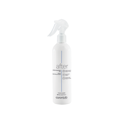 White spray bottle labeled after waxing oil  by caronlab on a white background