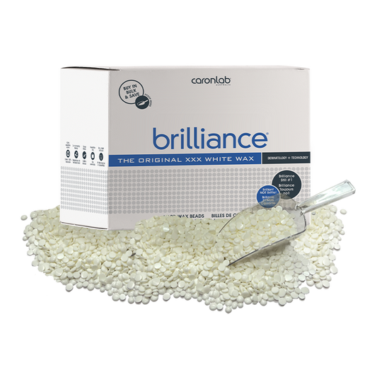 Box of Caronlab Brilliance white wax 5kg with a scoop and wax beads on a white background