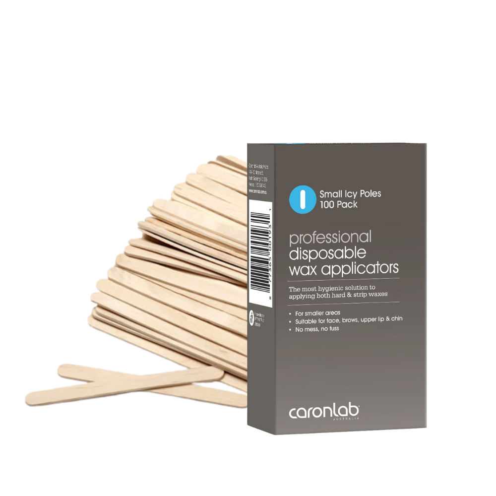 Box of professional disposable wax applicators with wooden waxing spatulas on a white background