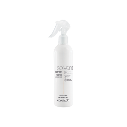 White spray bottle labeled 'solvent' by caronlab on a white background