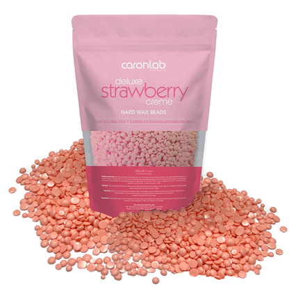 Pink packaging of Caronlab strawberry creme hard wax beads with wax beads spilling out on a white background.