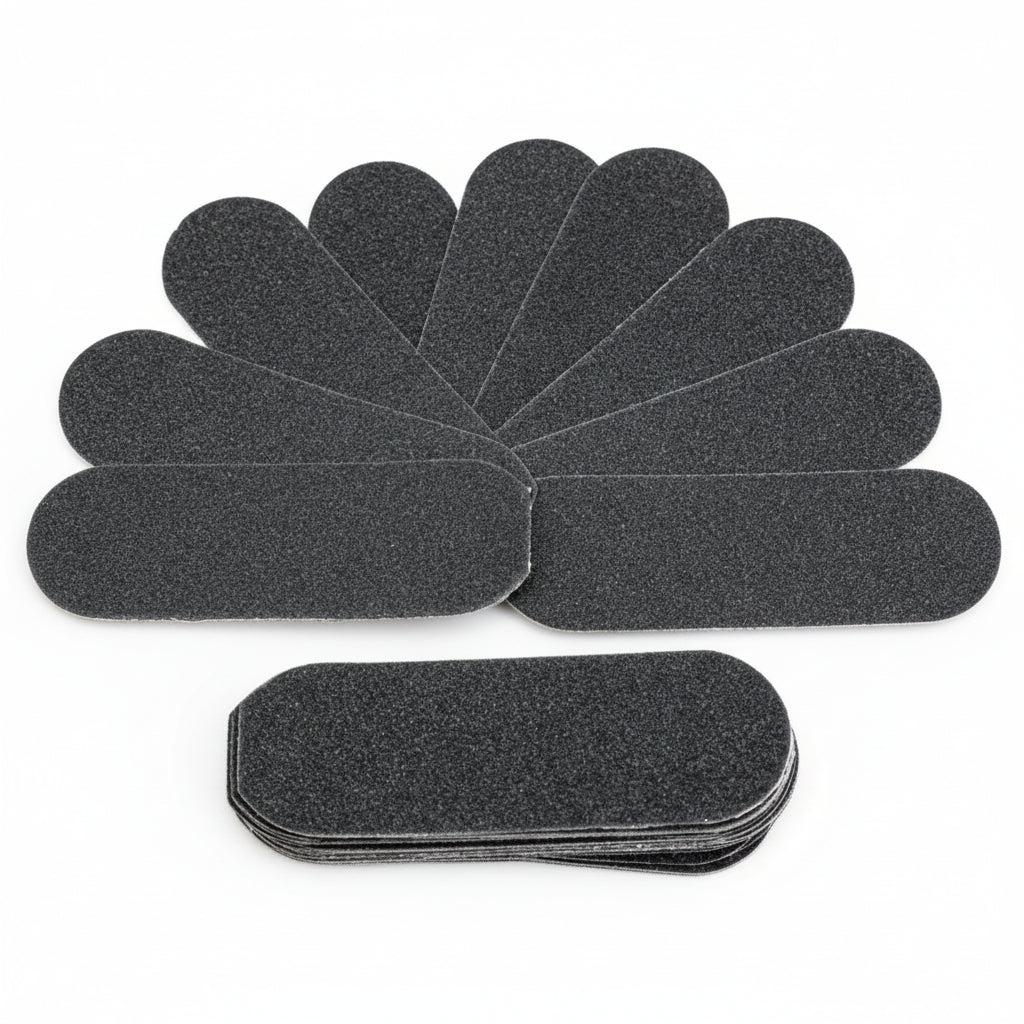 Set of black foot file sandpaper sheets on a white background