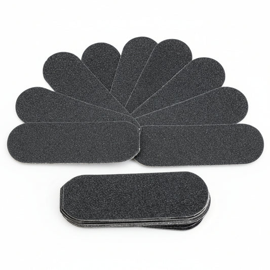 Set of black foot file sandpaper sheets on a white background