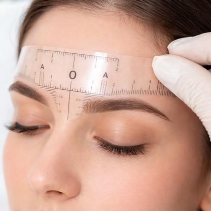Disposable eyebrow mapping ruler applied on client for precise brow shaping