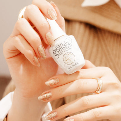 hand with Gelish All that Glitters Is Gold on the nails