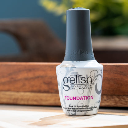 Gelish foundation base coat gel bottle on a wooden surface with a blurred background