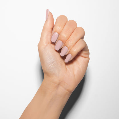 hand with Gelish Prim-rose and Proper on the nails