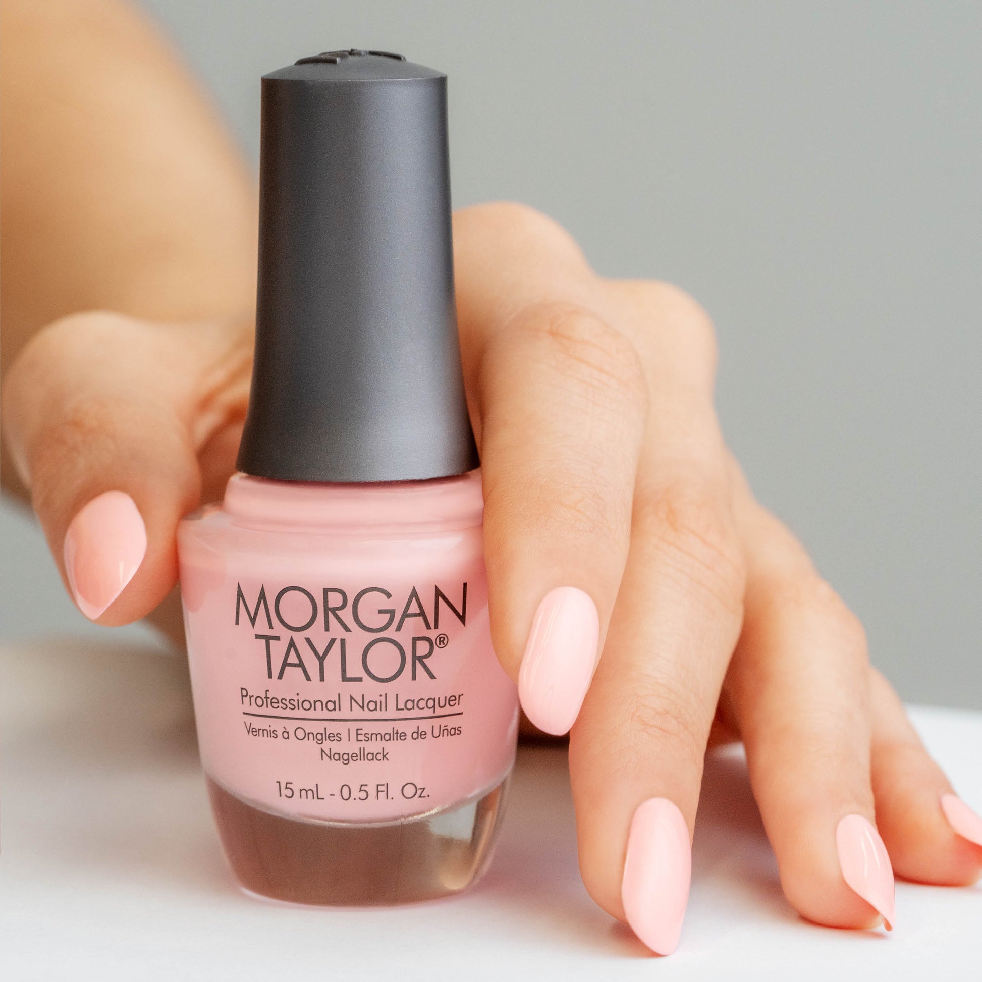 hand with Morgan Taylor All About The Pout on the nails