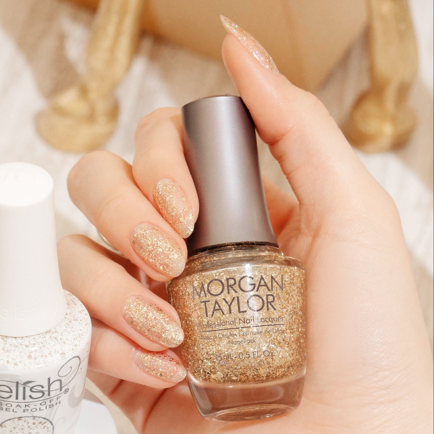 hand with Morgan Taylor All That Glitter Is Gold on the nails