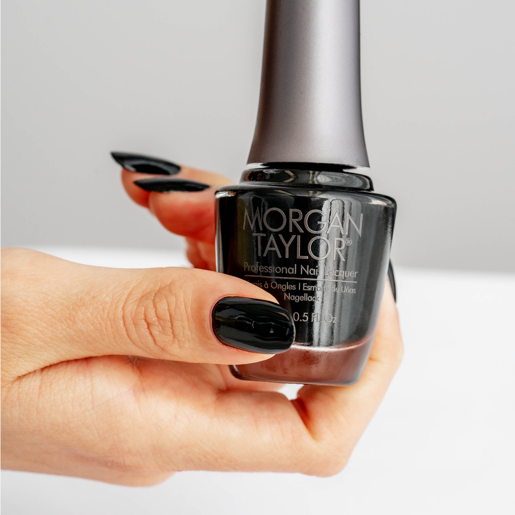 hand with Morgan Taylor Black Shadow on the nails