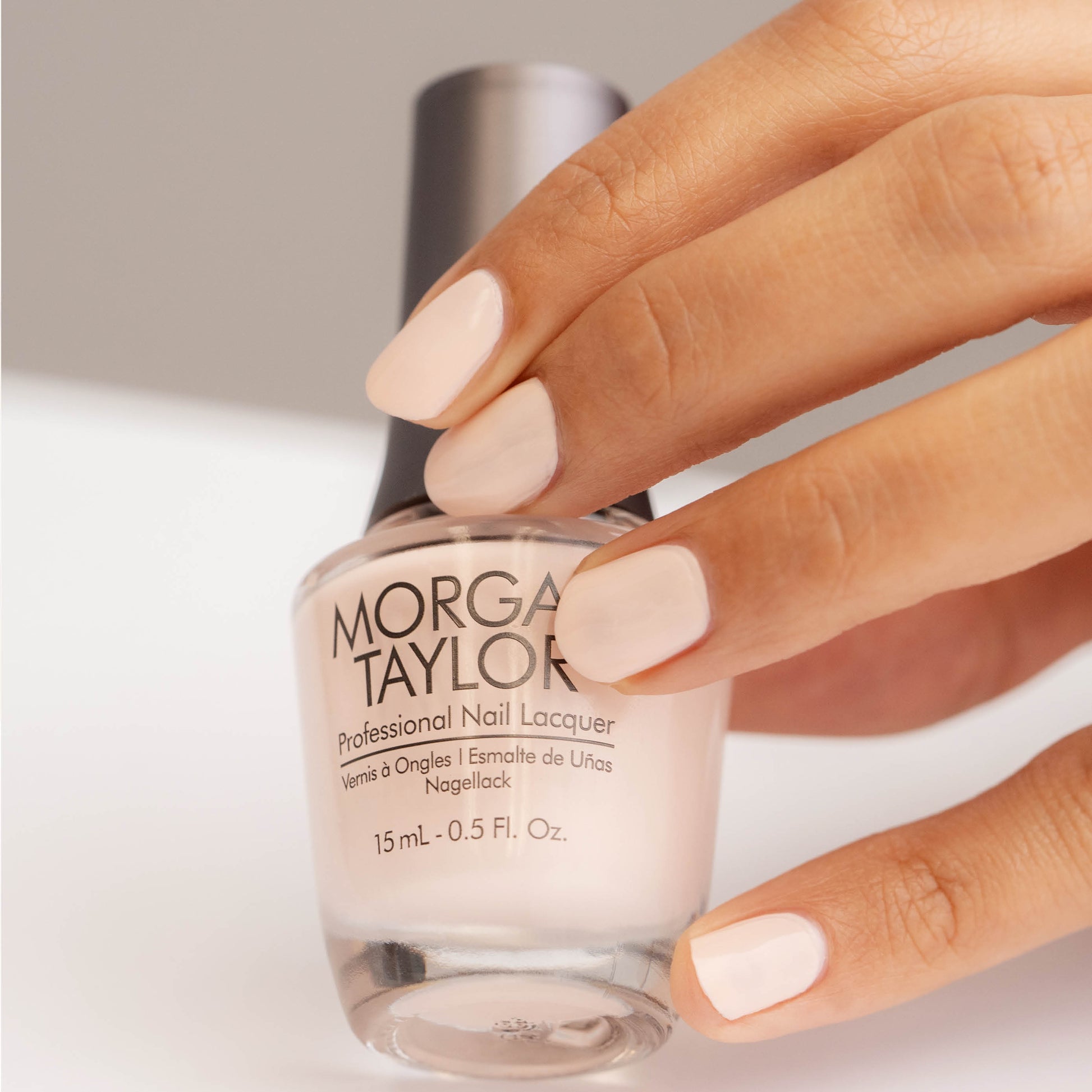 hand with Morgan Taylor Curls & Pearls on the nails