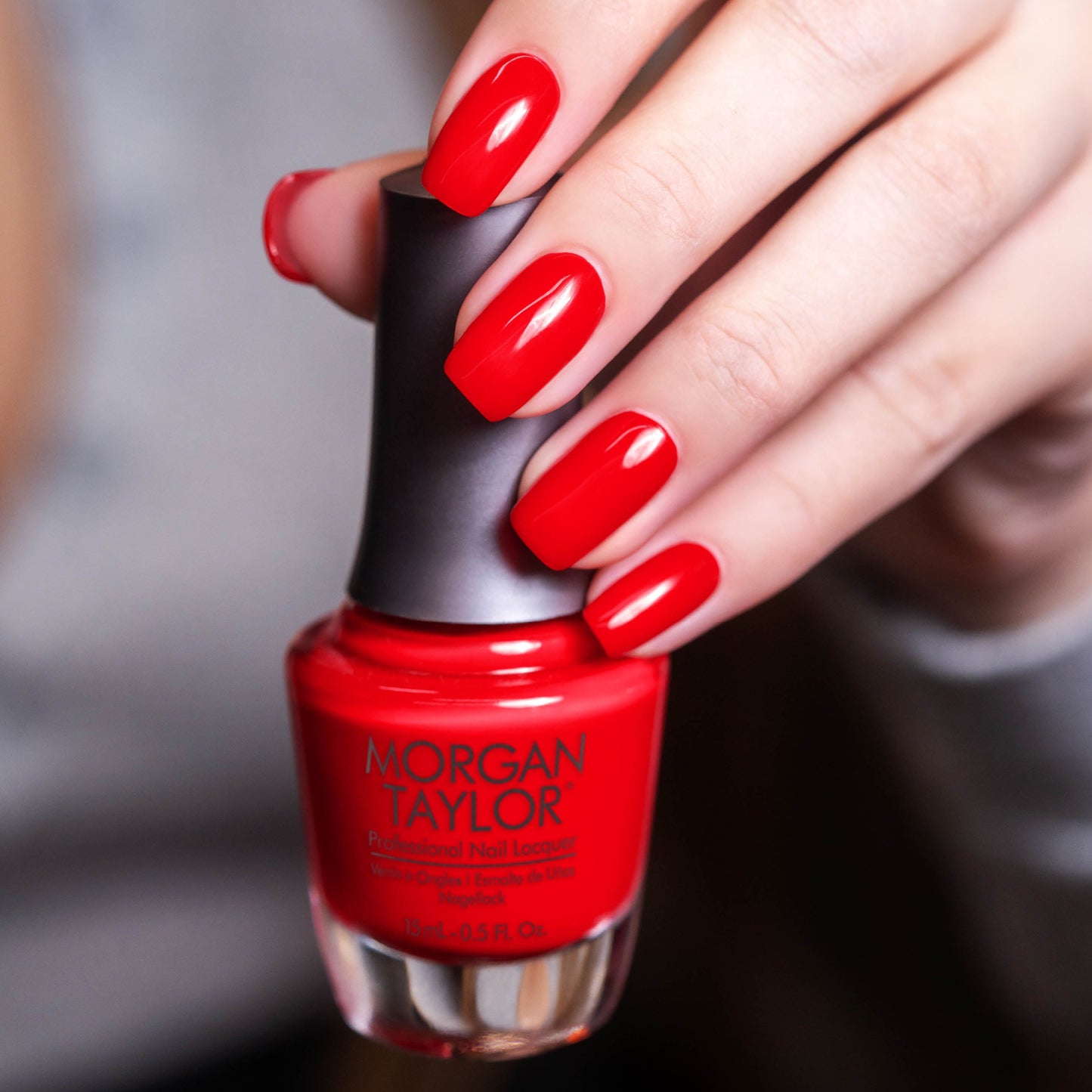 hand with Morgan Taylor Fire Cracker on the nails