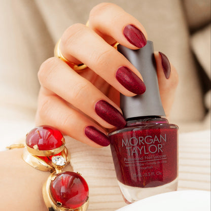 hand with Morgan Taylor Good Gossip on the nails