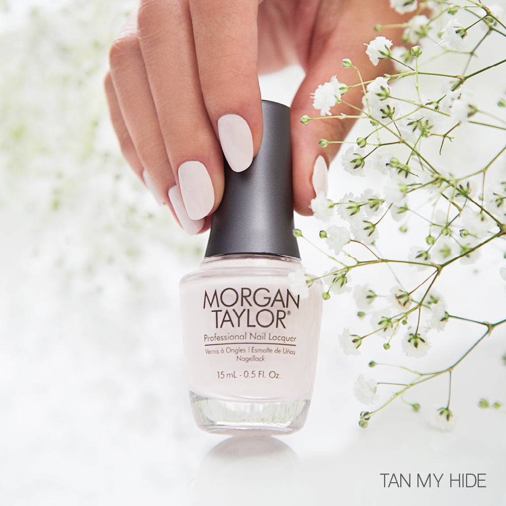 hand with Morgan Taylor Tan My Hide on the nails