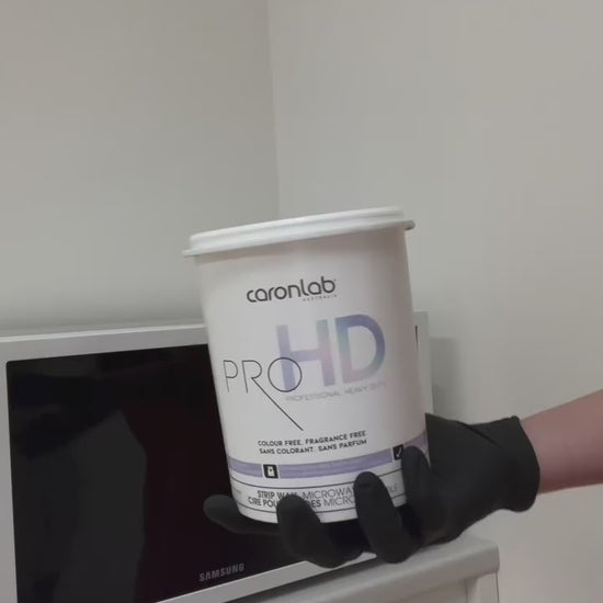 Caronlab Pro HD Strip Wax being heated and applied during a professional salon waxing treatment.
