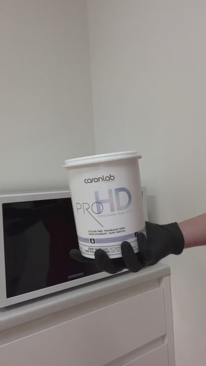 Caronlab Pro HD Strip Wax being heated and applied during a professional salon waxing treatment.