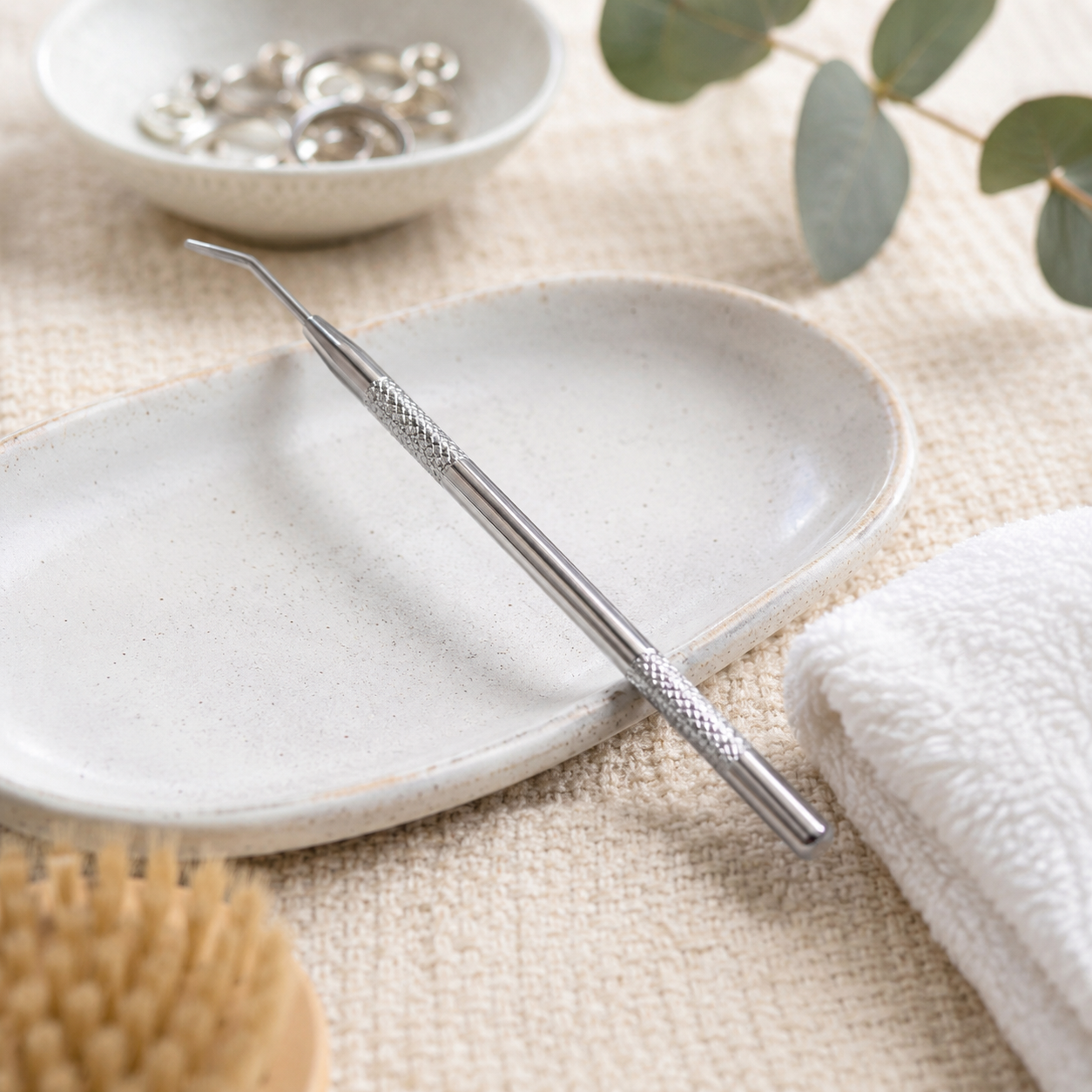 Professional metal lash lift separating tool displayed in a salon setting for precise lash separation during lash lift and brow lamination treatments.