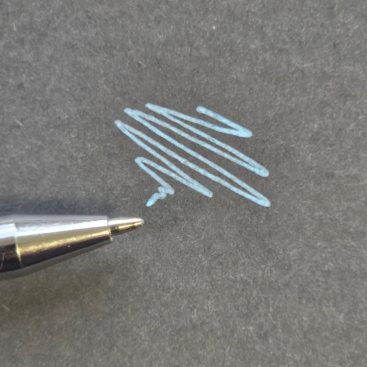 Blue professional skin mapping pen with fine precision tip and smooth pigment application on black background