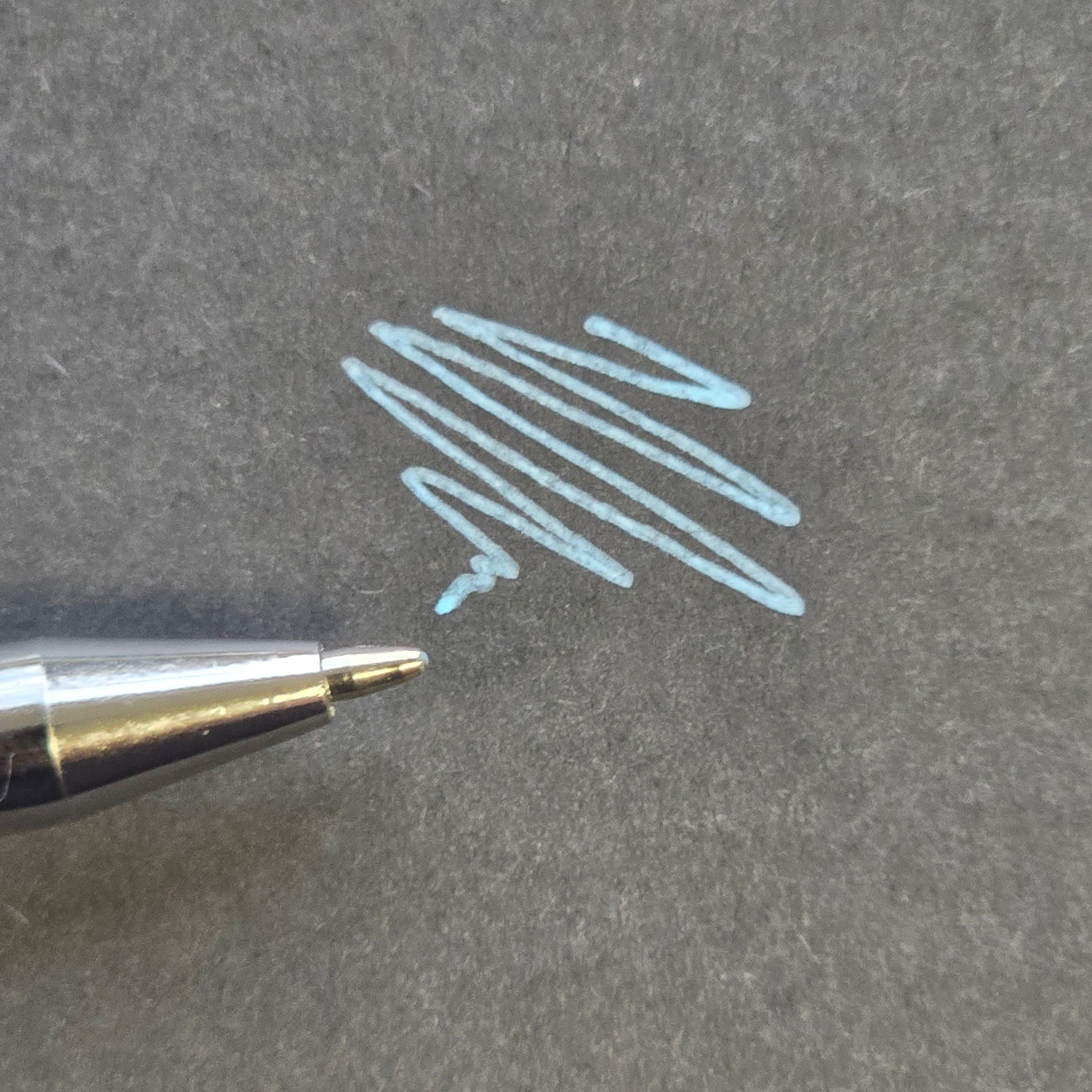 Blue professional skin mapping pen with fine precision tip and smooth pigment application on black background