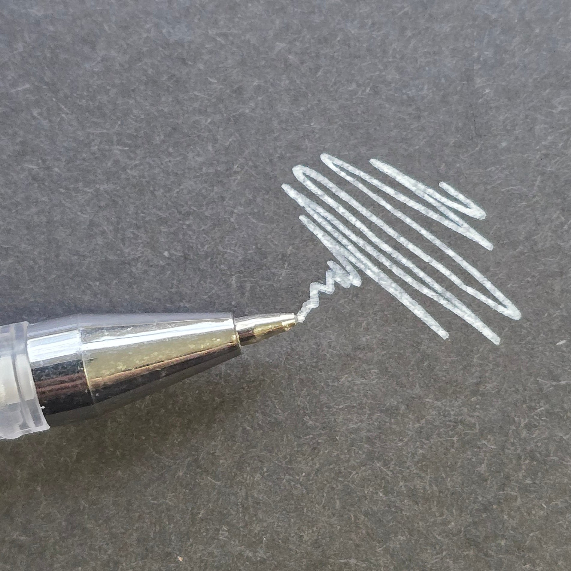 White professional brow mapping pen with fine precision applicator and visible pigment swatch