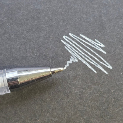 White professional brow mapping pen with fine precision applicator and visible pigment swatch